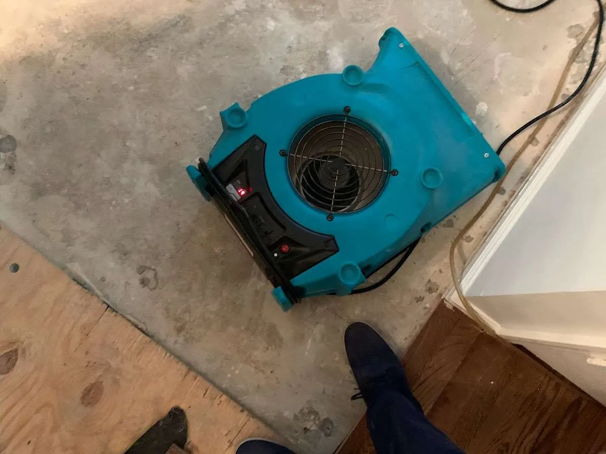 Air mover drying subfloor during Commercial Water Damage Restoration in Aspen
